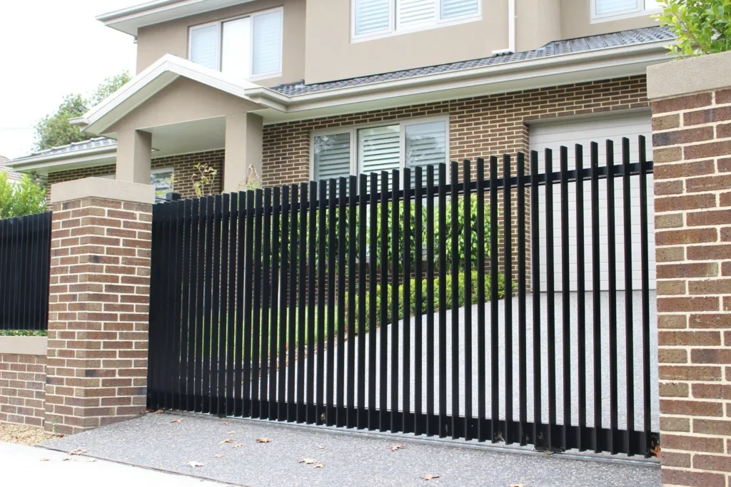 Black metal security gate and matching fencing installed at a residential property